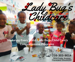 Children at Lady Bugs Child Care standing around a table, smiling, and proudly displaying their work.