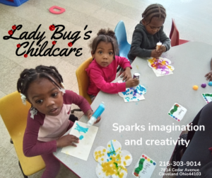 Children at daycare proudly displaying their creativity showing off their artwork while seated around a table, smiling.